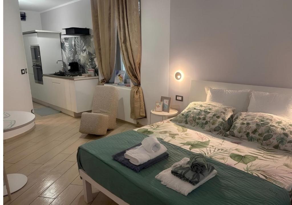 a bedroom with a bed with towels on it at Casa Acquarello in Savona
