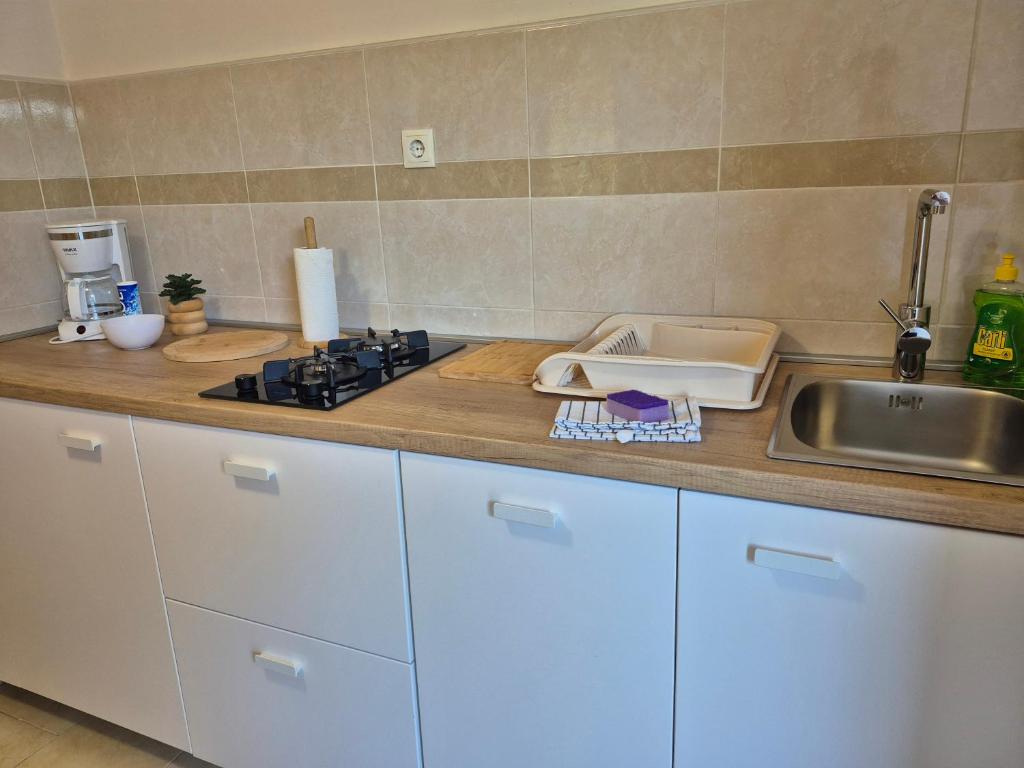 a kitchen counter with a sink and a stove at Studio for short stay in Rabac