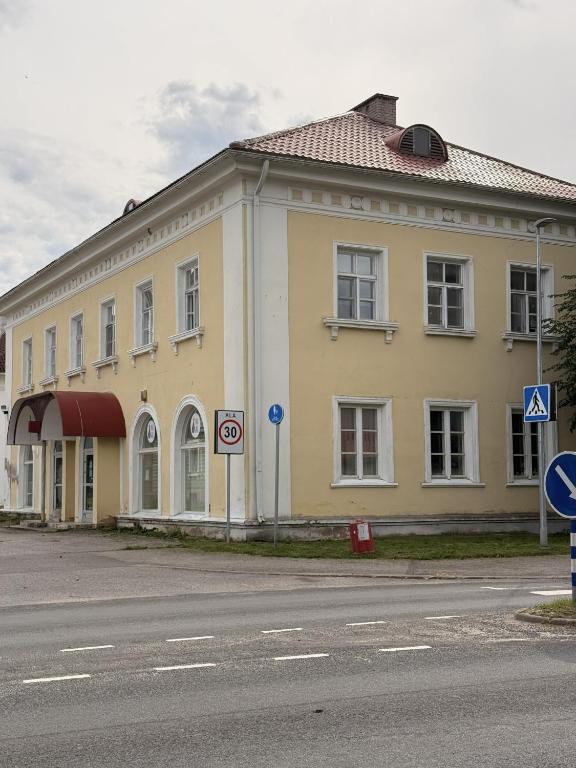 a yellow building on the side of a street at LIINA apartment in Vahtseliina