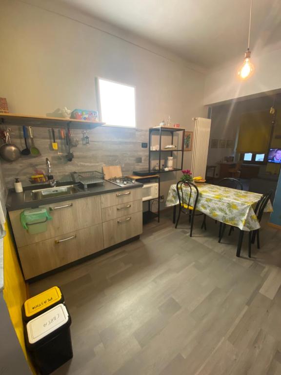 a kitchen with a table and a sink and a table and a table at Pinerolo medievale in Pinerolo