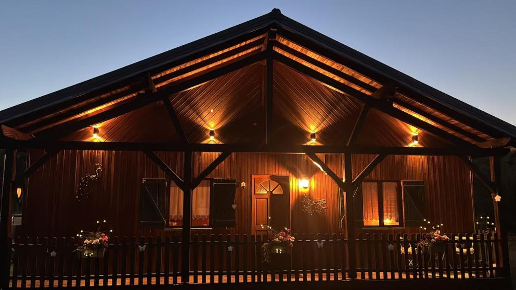 a house with lights on the front of it at Le Chalet Hubertus - Climatisé - 80 m2 in Rohrbach-lès-Bitche