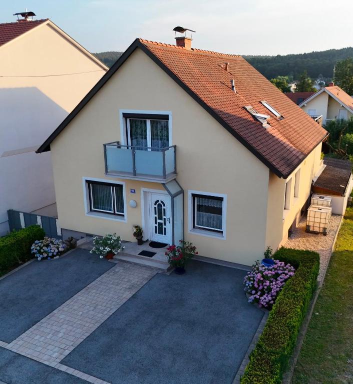 a white house with a red roof at Ferienwohnung Rebekka in Riedlingsdorf