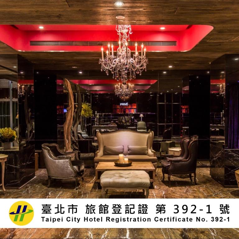 a lobby of a hotel with a couch and chairs at inhouse Hotel in Taipei