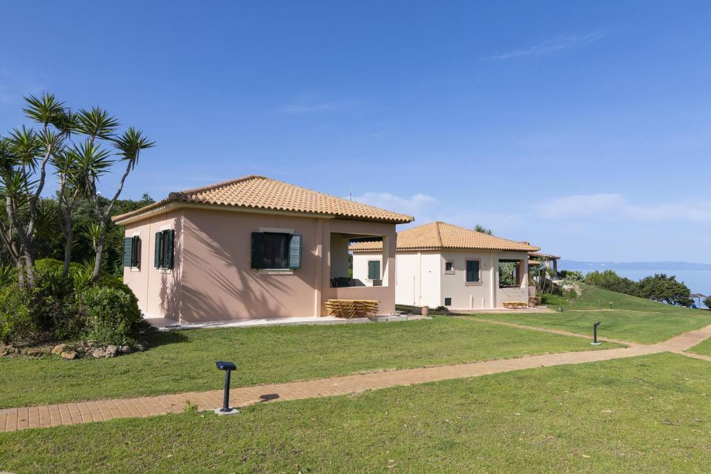 a house on a hill with a pathway to it at Analipsi Villas Beach Front in Kástro Tornéze