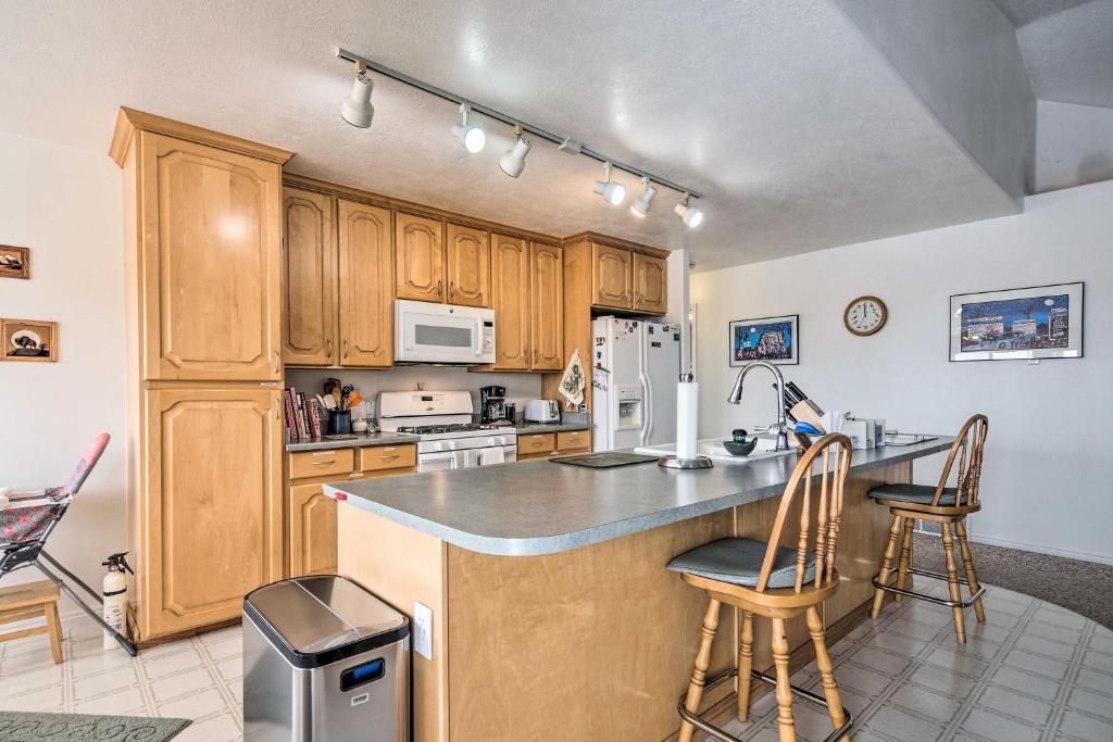 a kitchen with wooden cabinets and a counter top at ATV Trail Access & Mtn Views! 2-Unit Group Retreat in Aurora