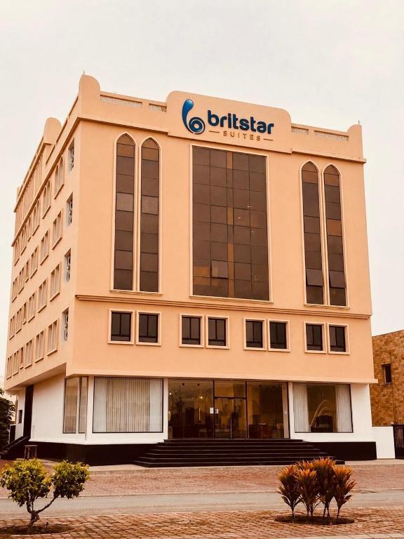 a building with a britisher sign on top of it at Britstar Suites Salalah in Salalah