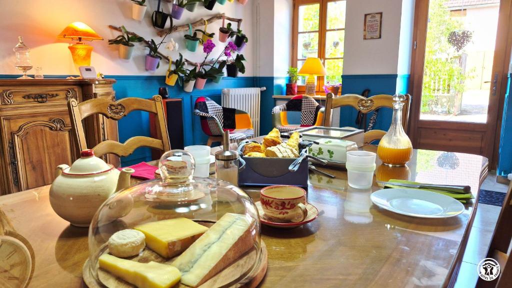 a table with a glass bowl of cheese on it at Chez l'tiote morvandelle in Montigny-en-Morvan