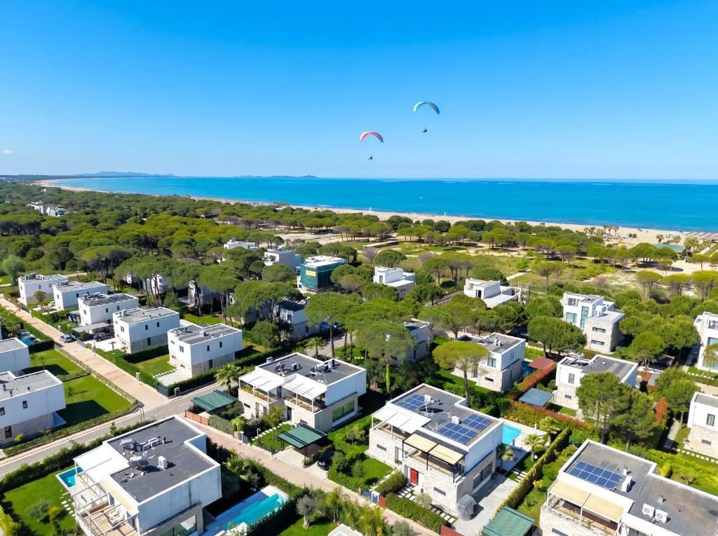 an aerial view of a city with houses and the ocean at Olive Tree Apartment - 290 in Mullini i Danit