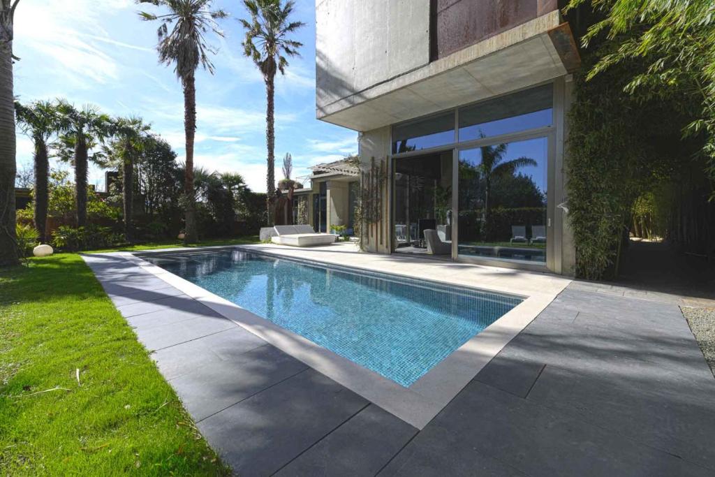 a swimming pool in the backyard of a house at Villa Nola - Diseño Vasco, Lujo y Privacidad in San Sebastián