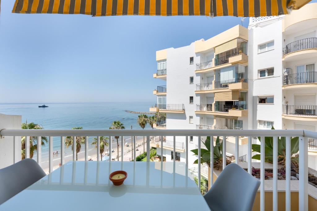 a balcony with a view of the ocean at Apartment Overlooking the Beach in Marbella