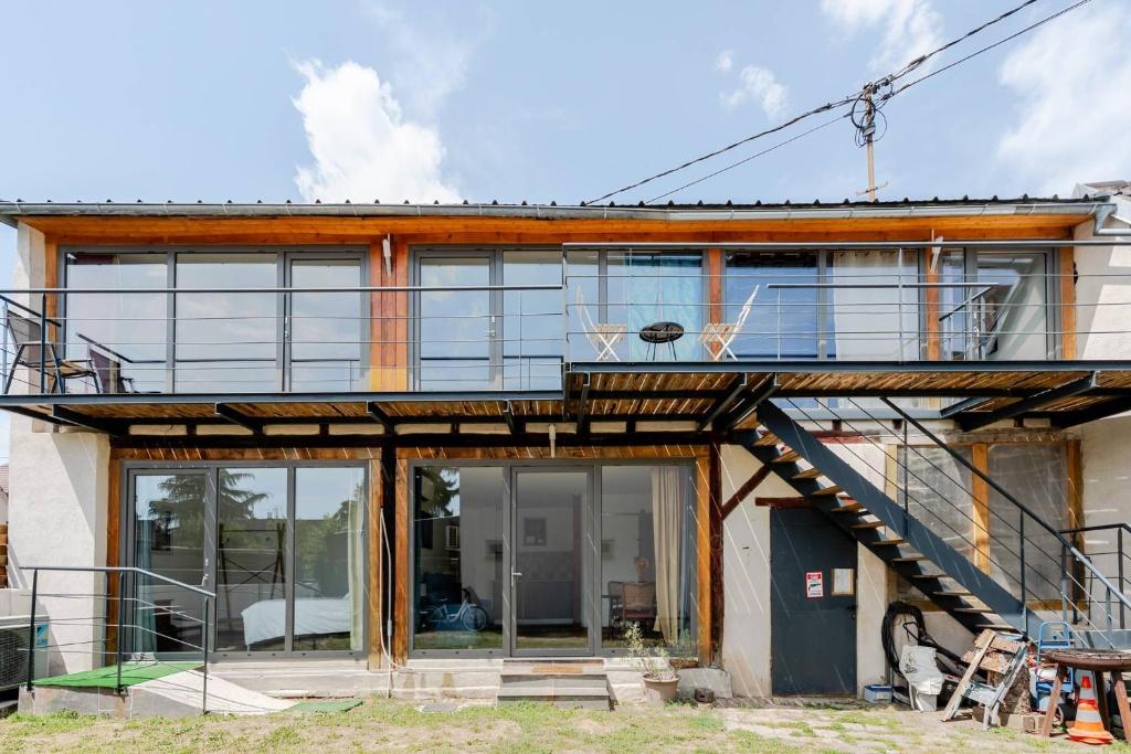 a house with large glass windows and a staircase at La Grange in Reichstett