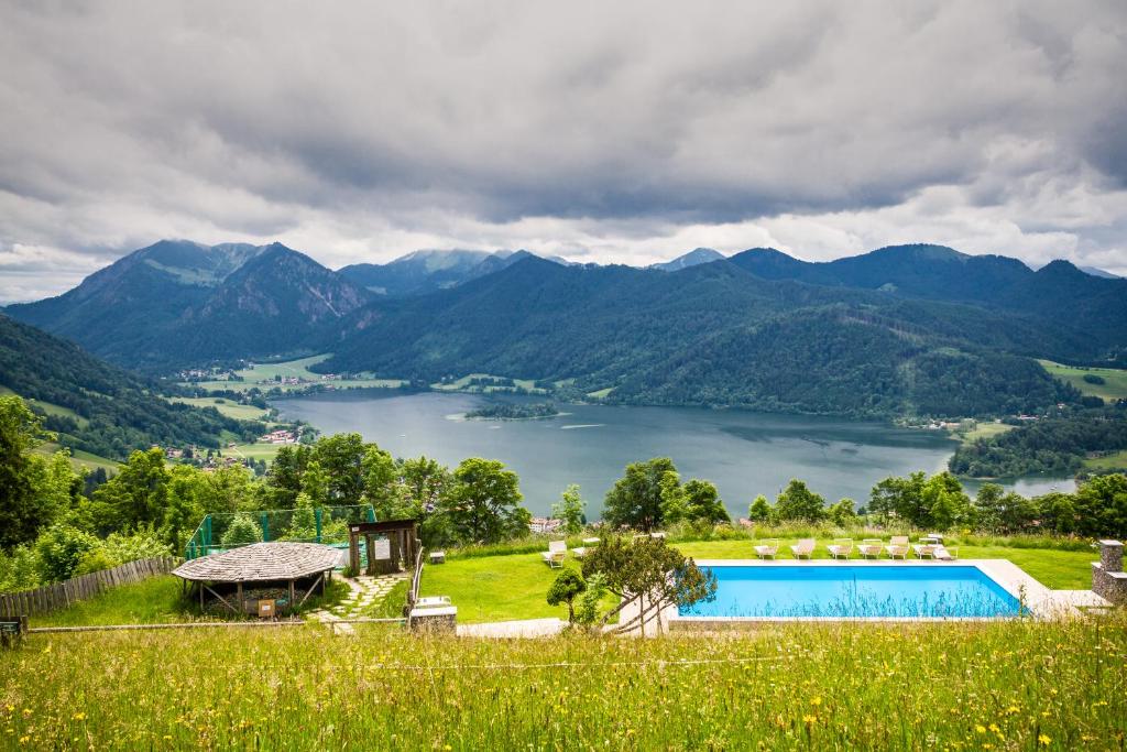 a villa with a view of a lake and mountains at Schliersberg Alm in Schliersee