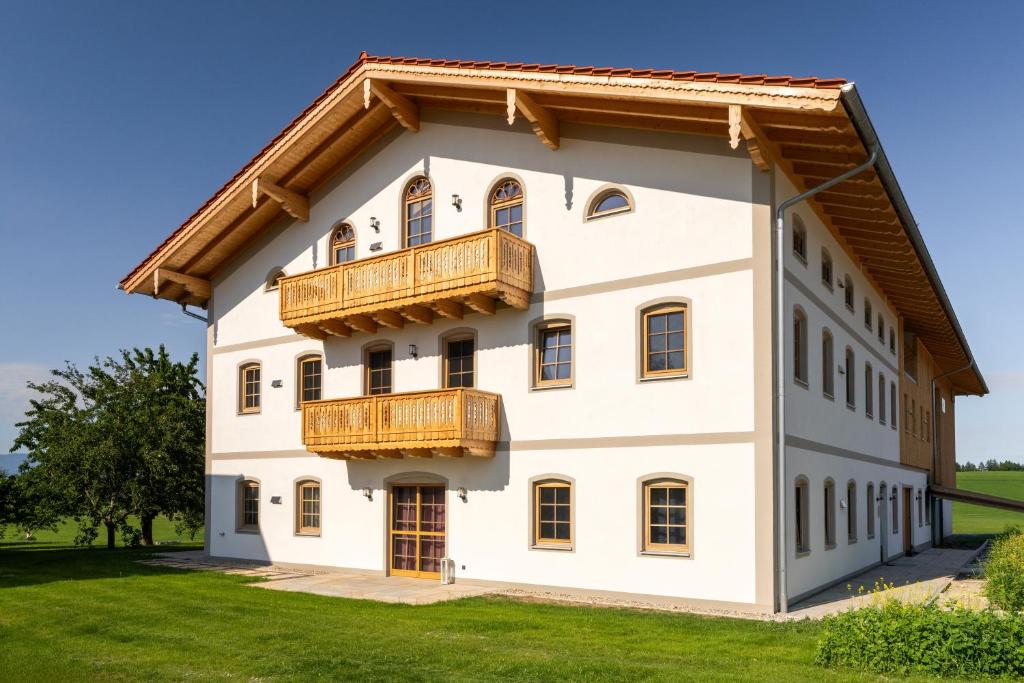 a large white building with a balcony at Ferienwohnungen Schmiedhof in Eggstätt