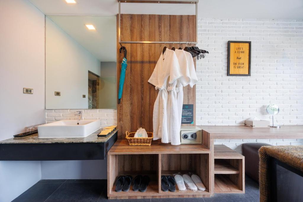 An open-plan vanity area sits beside a wardrobe, seating nook and work surface.