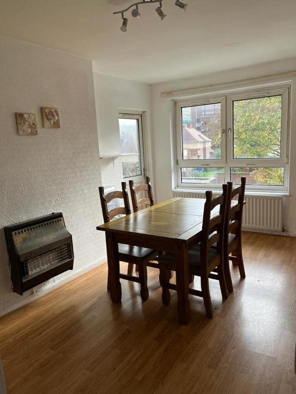 a dining room with a wooden table and chairs at Budget Central Birmingham in Birmingham