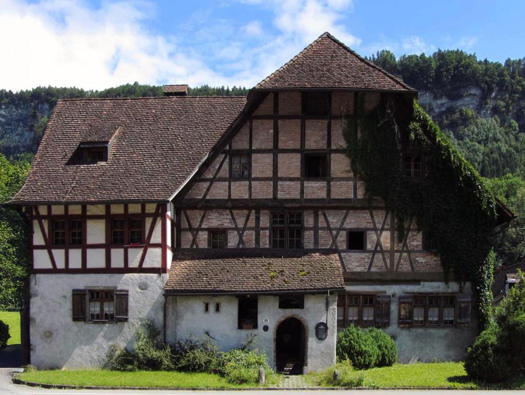 a large house with a roof at Hostel Feldkirch in Feldkirch