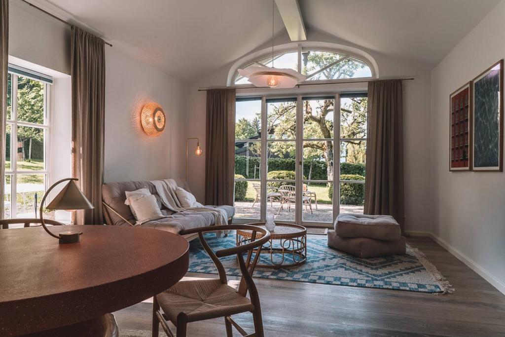 a living room with a table and a couch at Apartment Søglas in Gmund am Tegernsee