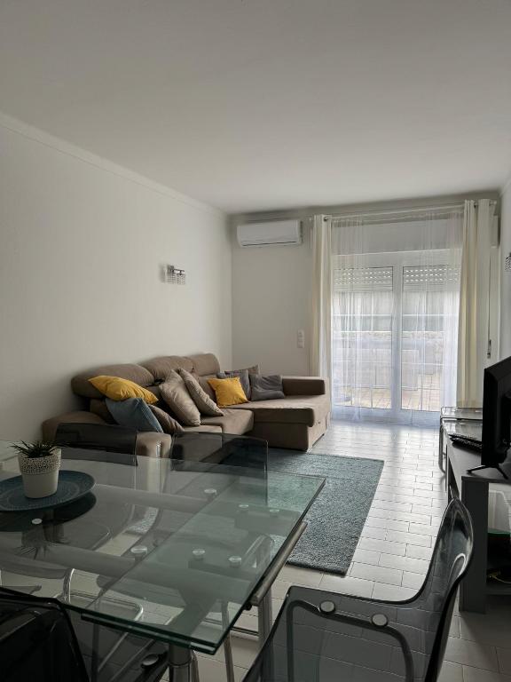 a living room with a glass table and a couch at Seabreeze T3 in Carvoeiro