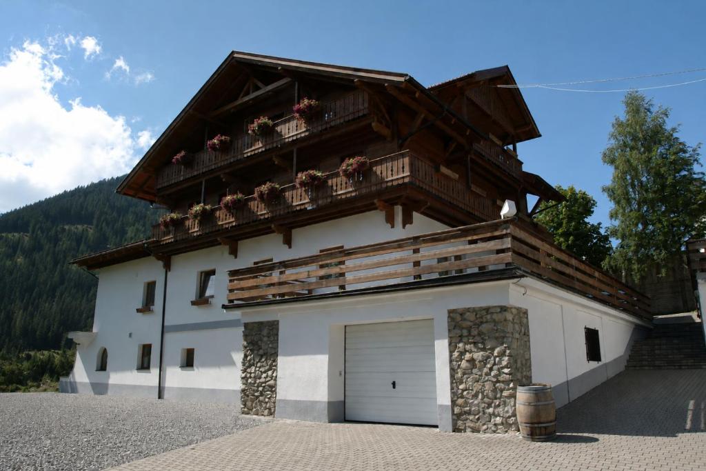 a large white building with a garage at Chalet Rotenstein in Berwang