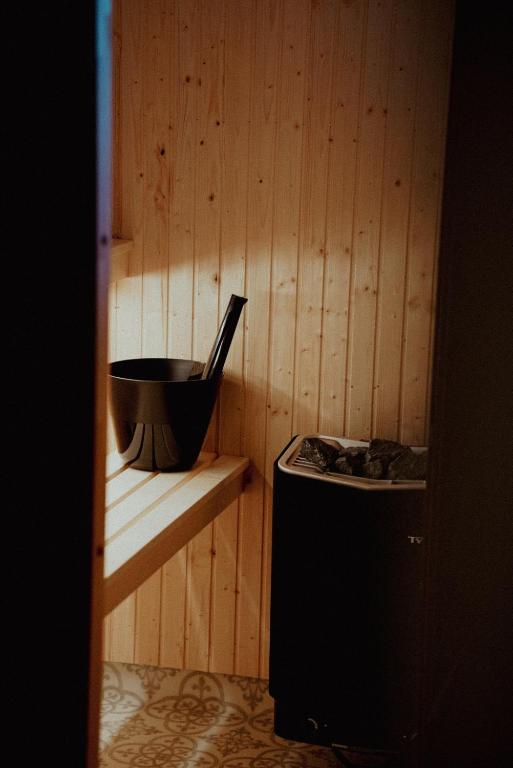 a wooden wall with a bowl on a shelf next to a stove at Bjursås Bergsgård in Bjursås
