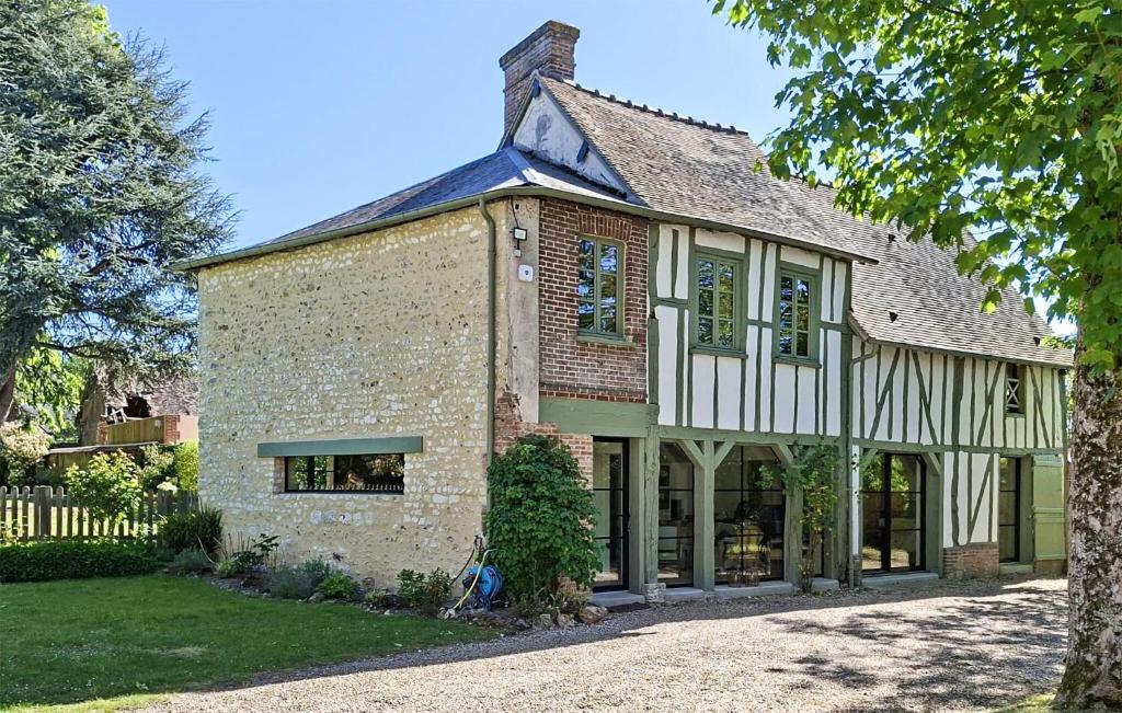 a large brick building with windows and a roof at Lovely Home In Clef Vallée D'eure in La Croix-Saint-Leufroy