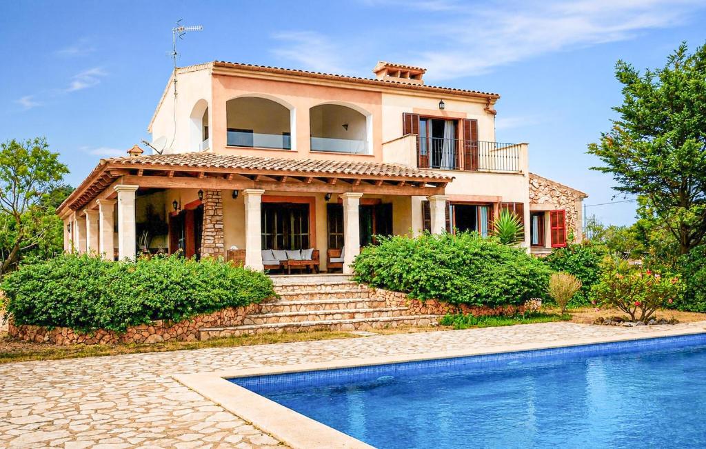 a house with a swimming pool in front of it at Sa Tanqueta De Calonge in Santanyi