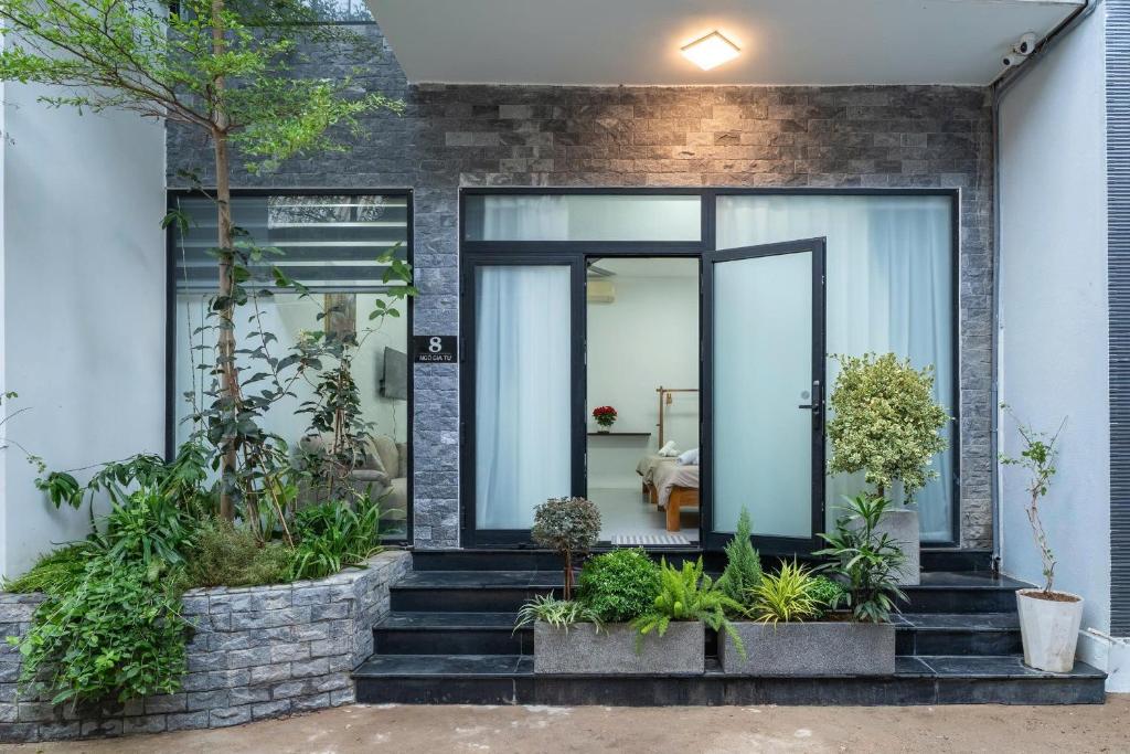 a home with glass doors and plants on the stairs at Dreams Boutique House in Hue City Center in Hue