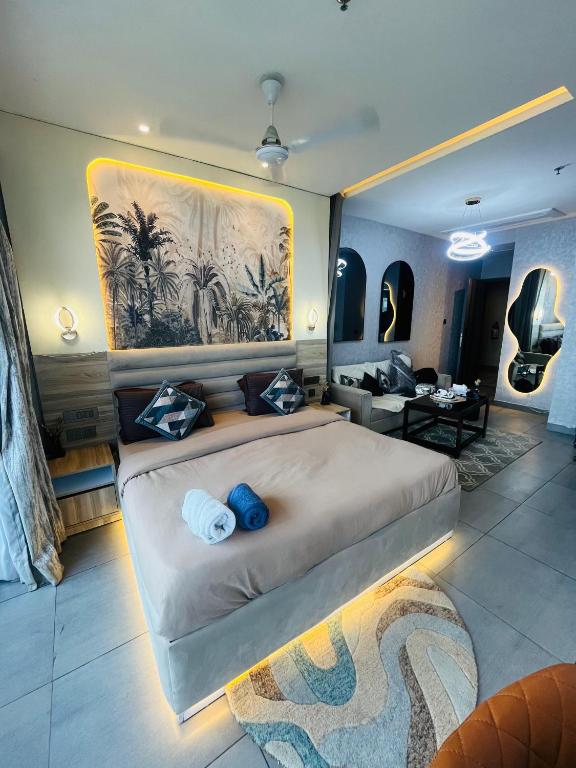 a bedroom with a large bed and a living room at Supernova luxe heaven in New Delhi
