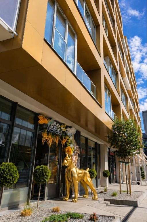a statue of a lion outside of a building at JBHotels Apartament DeLuxe przy Galaxy in Szczecin