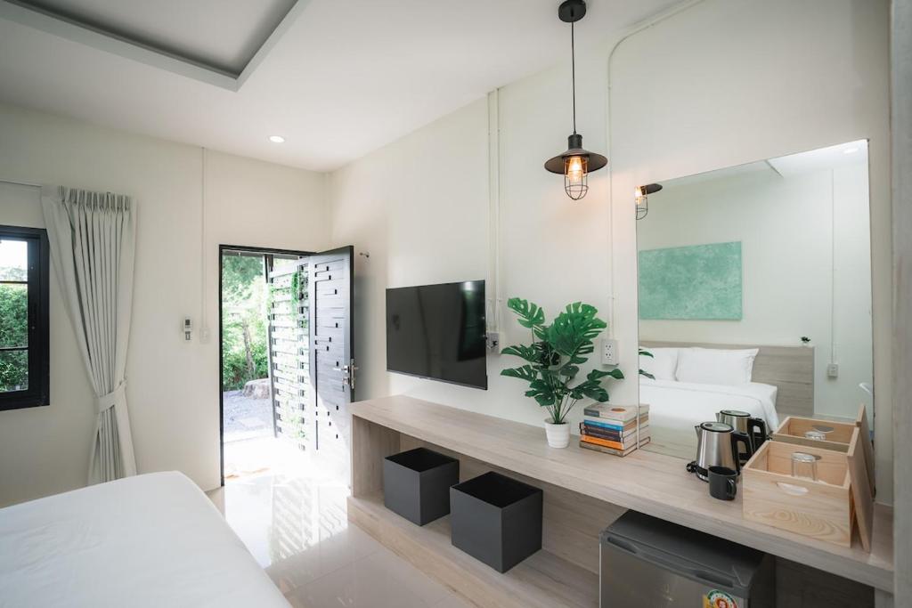 a bedroom with a bed and a large mirror at Sandana Studio Apartments - Studio 2 in Nathon Bay