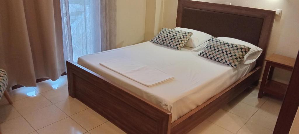 a bed with two pillows on it in a room at Villa Bianca in Kremasti