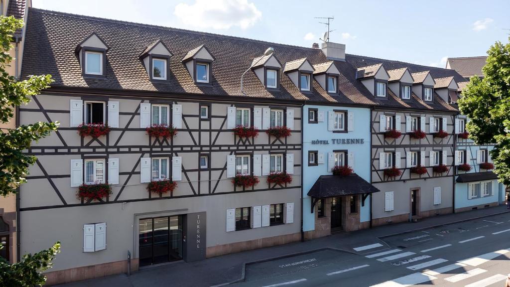 a large white building with a lot of windows at Hôtel Maison Turenne in Colmar