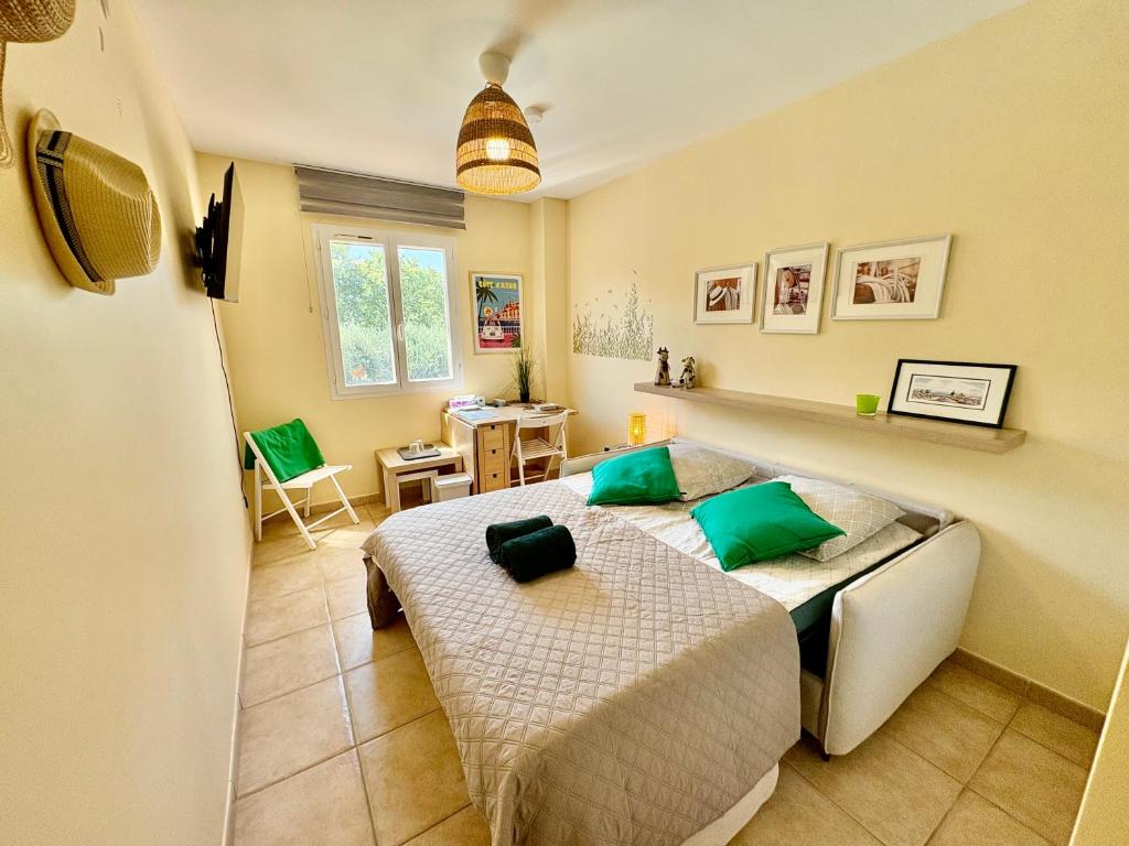 a bedroom with two beds and a desk in it at Les Carnoulettes in Carnoules