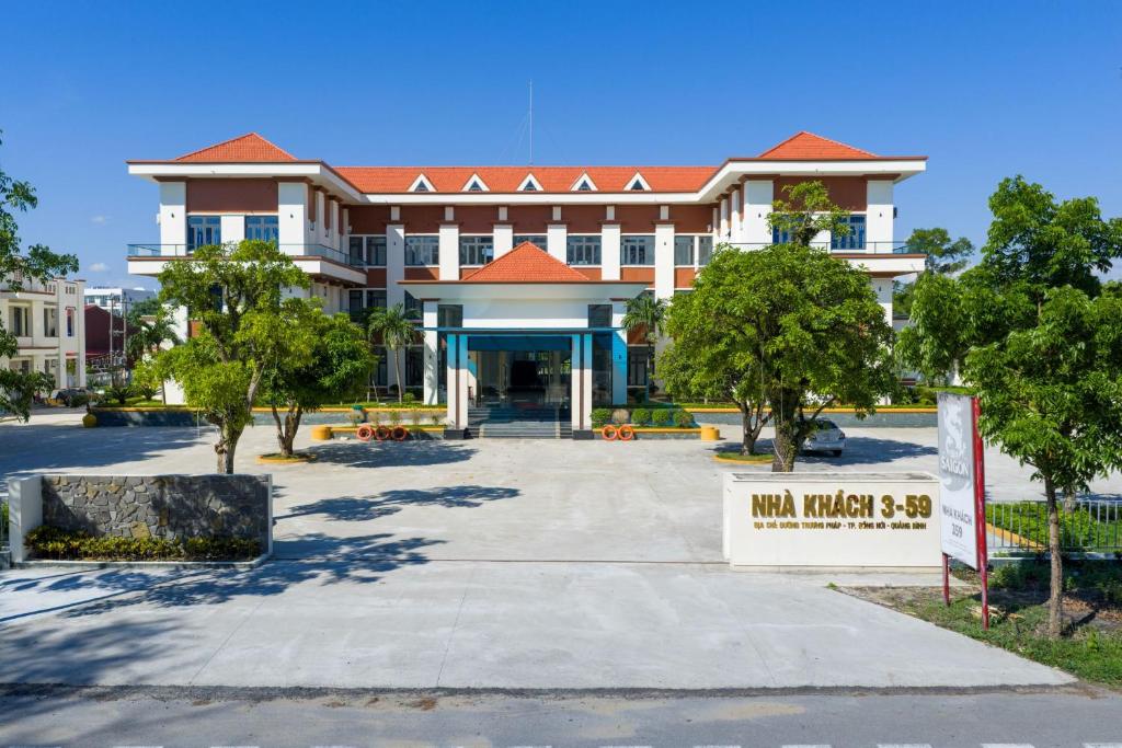 a large building with a sign in front of it at 359 Beach Hotel in Phú Xá