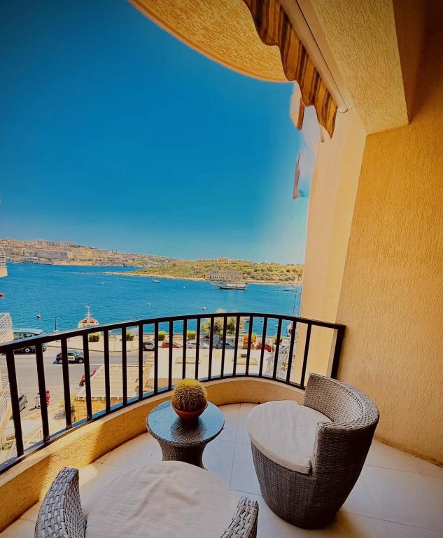 a balcony with chairs and a view of the water at Prime Located Home by *The Sea* in Sliema