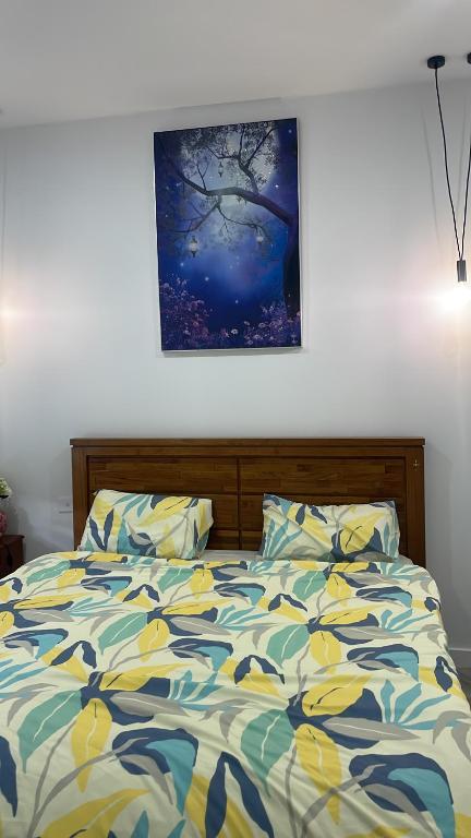 a bedroom with a bed with a painting on the wall at Ballarat home in Ballarat