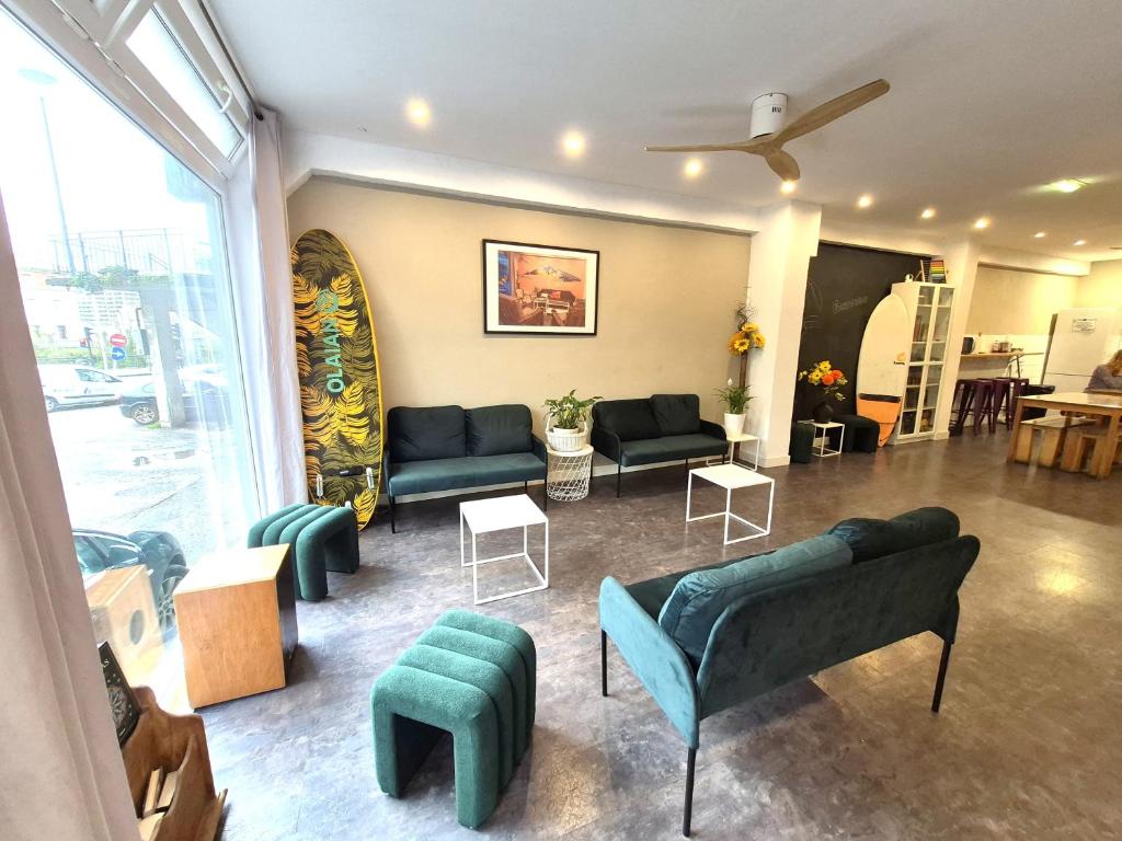 a living room with couches and chairs in a room at Balea Hostel in San Sebastián
