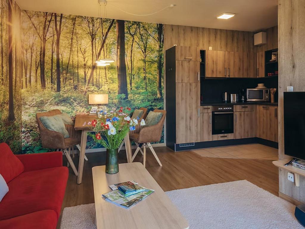a living room with a red couch and a table at Apartment Hainich in Mühlhausen
