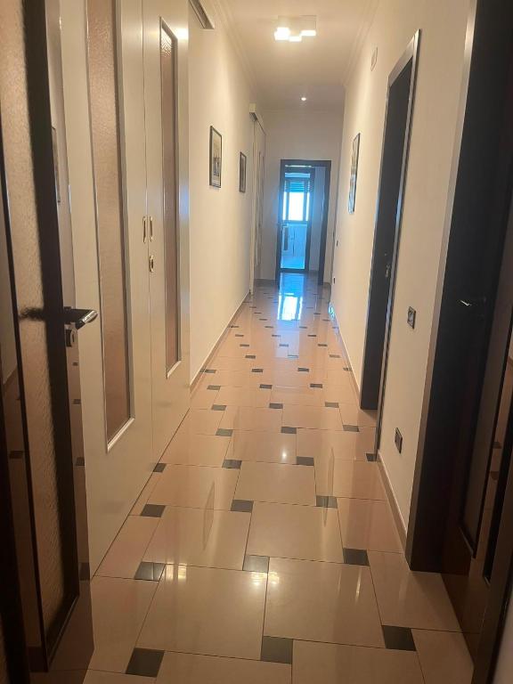 a hallway with a tile floor and a door at Casa 2019 in Matera