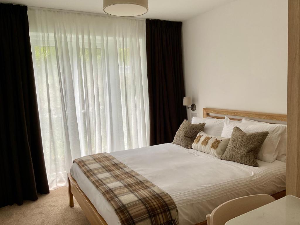 a bedroom with a bed and a large window at Gara-Ni Bed & Breakfast in Fort William
