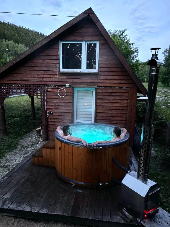 a hot tub in a house with two people in it at Chata Ignasia in Stronie Śląskie