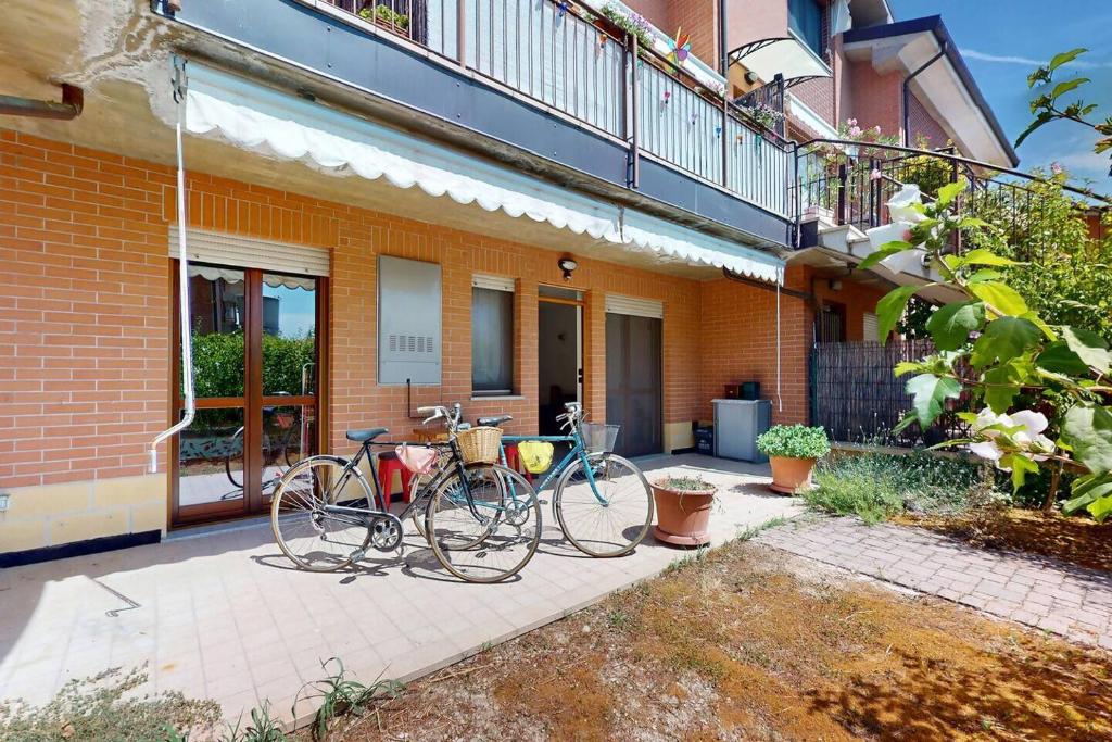 two bikes parked in front of a building at [BuenRetiro] Giardino, box e bici a disposizione in Acqui Terme