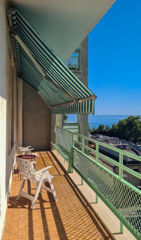 a balcony with a table and a bench on a building at Miramare Apartment in Ancona