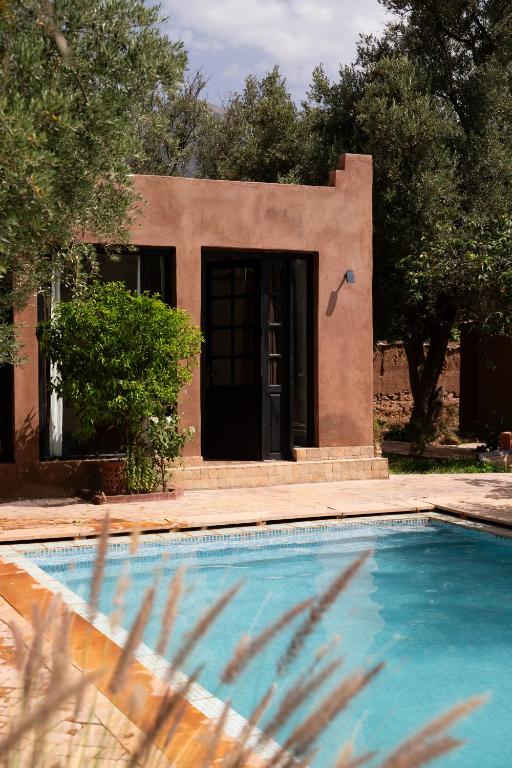 a house with a swimming pool in front of a house at Villa Quince in Ouirgane