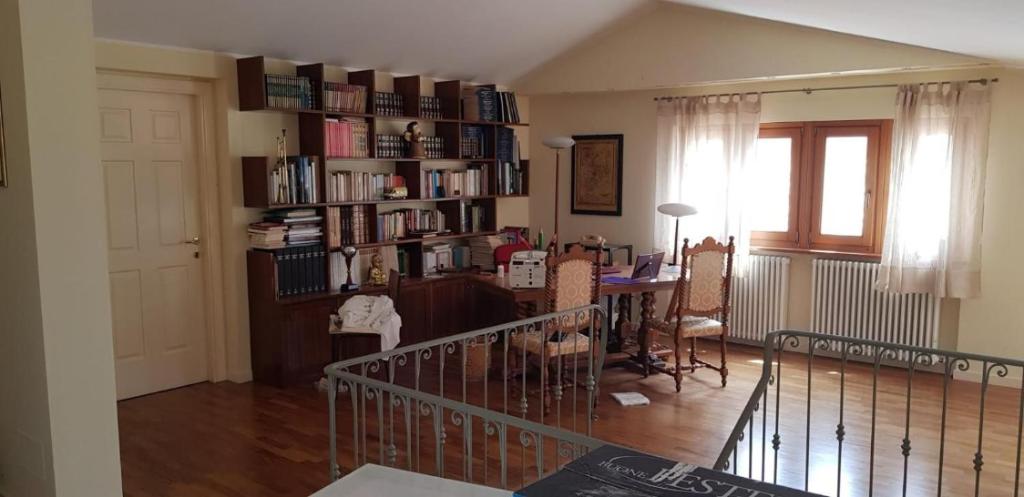 a living room with a table and a book shelf at Appartamento "Sul Corso" Atessa in Atessa