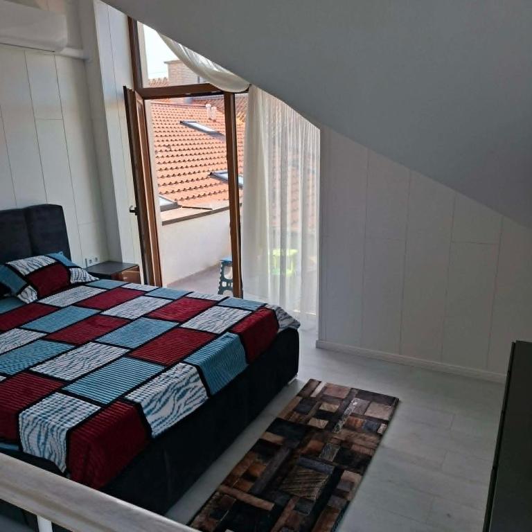 a bedroom with a bed and a window at Melnaragė in Melnragė