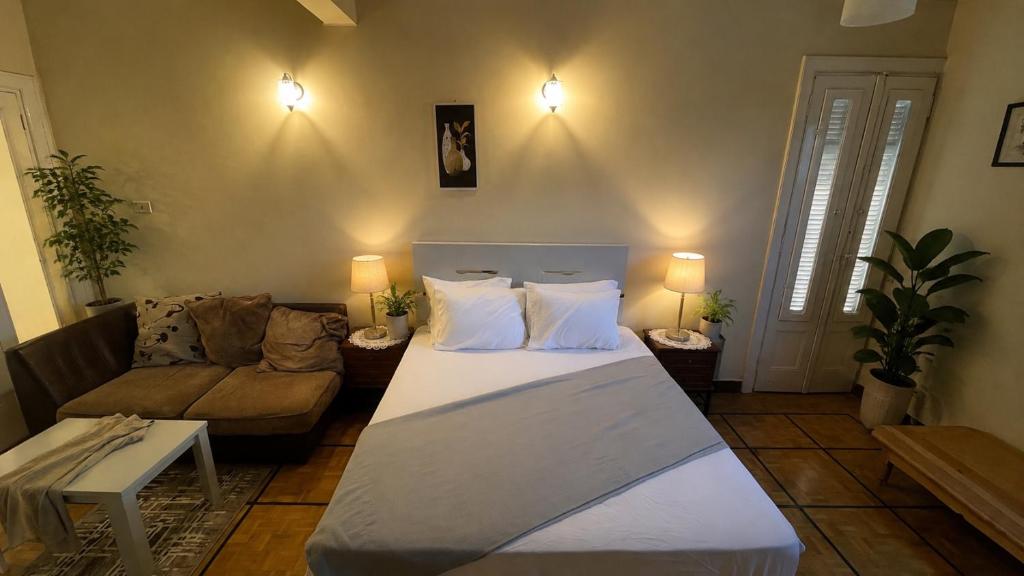 a living room with two beds and a couch at Stay Ra3 Suites in Cairo