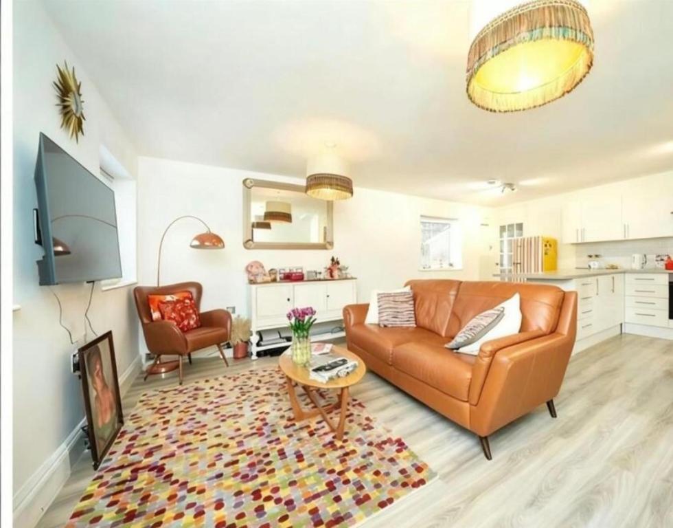 a living room with a couch and a table at 1 Bed Apartment Sleeps 2 -Free Parking -WiFi & Tv in Sutton Coldfield