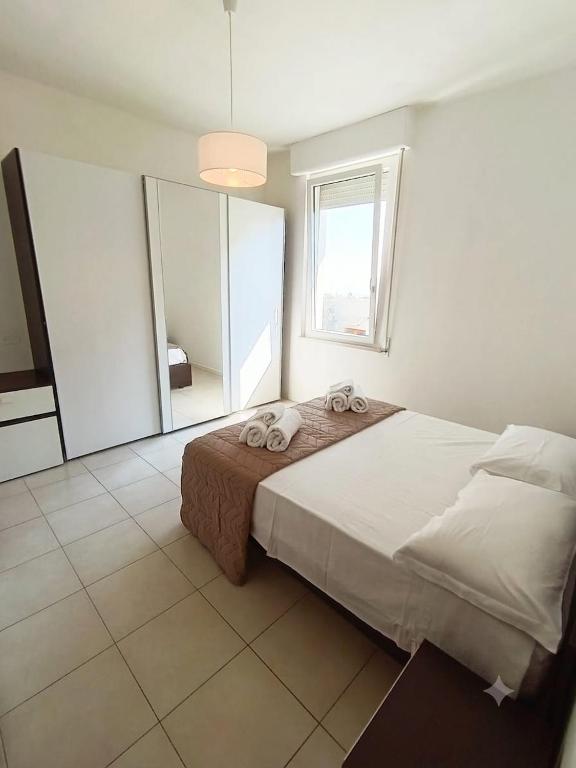 a bedroom with a large bed and a large mirror at Free Parking a 100 mt dal mare-Wave HuoSe in Pesaro