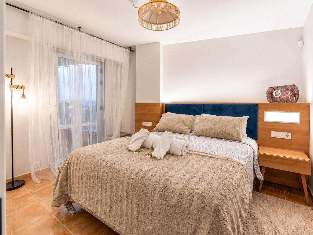 a bedroom with a bed with two stuffed animals on it at Apt. Xaramiños Galitrips in Corcubión